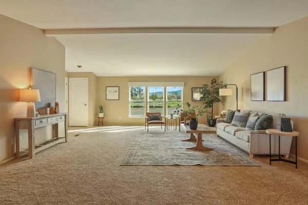 a kitchen with stainless steel appliances kitchen island granite countertop a dining table chairs and sink