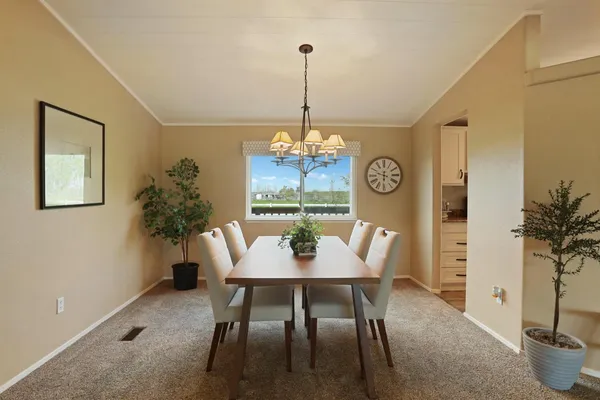 a kitchen with counter space dining table and stainless steel appliances