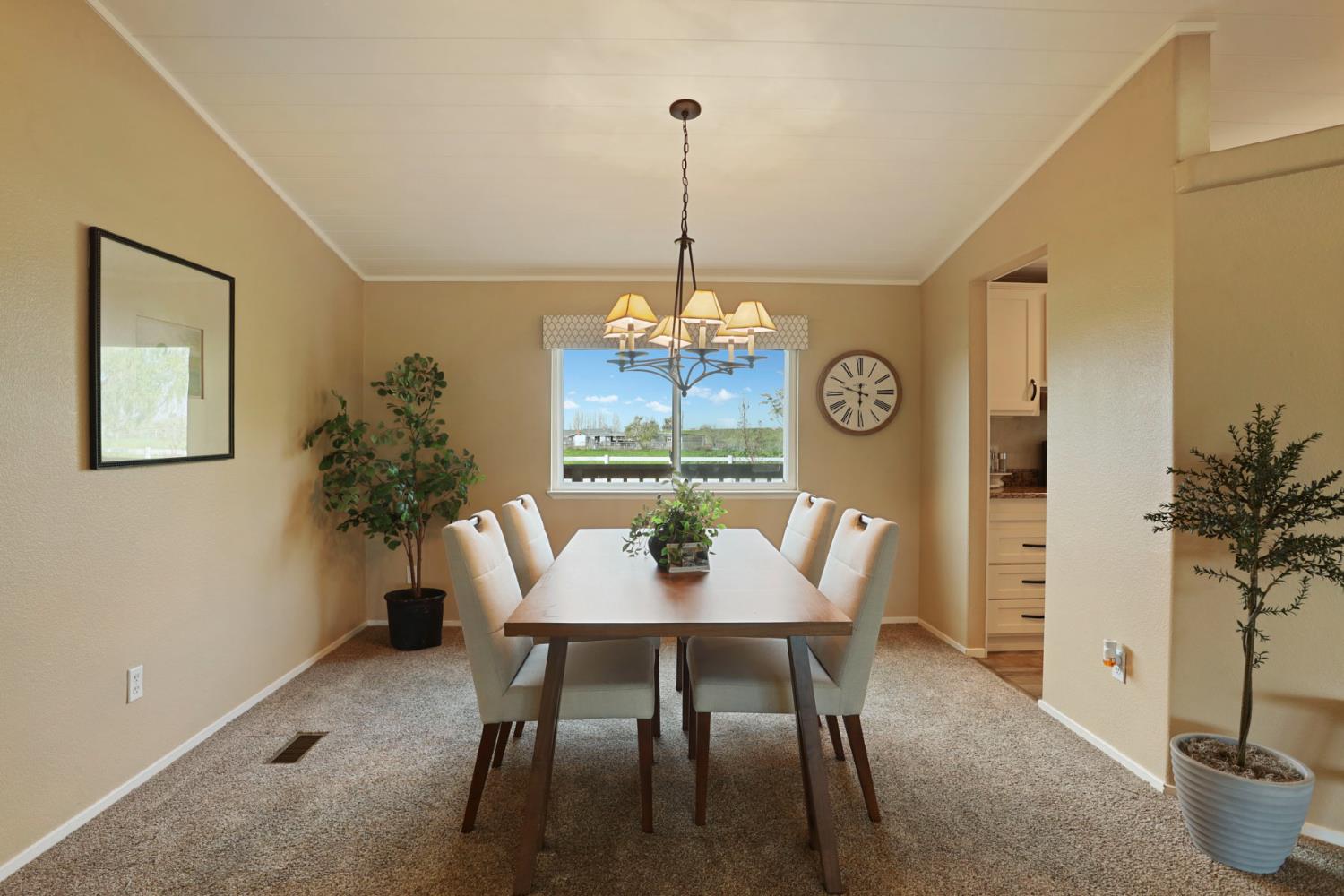 3320 Durham Ferry Road Tracy, CA 95304 - Photo 16 of 77 a view of a dining room with furniture window and wooden floor