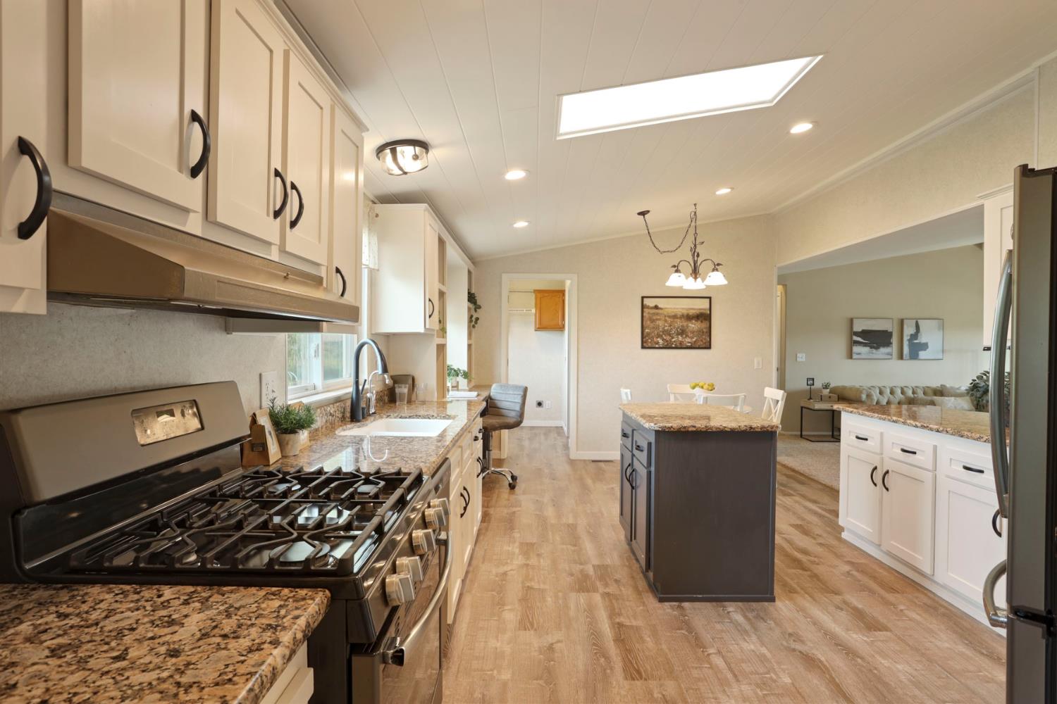 3320 Durham Ferry Road Tracy, CA 95304 - Photo 18 of 77 a kitchen with stainless steel appliances granite countertop a stove and a wooden floors