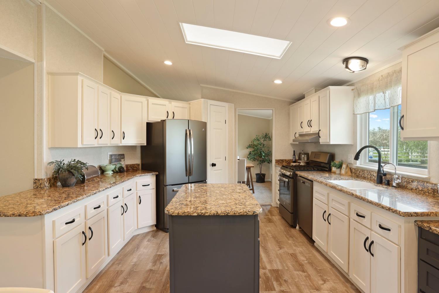 3320 Durham Ferry Road Tracy, CA 95304 - Photo 20 of 77 a large kitchen with stainless steel appliances kitchen island granite countertop a sink and cabinets