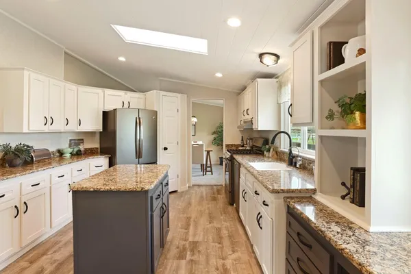 a living room with furniture and kitchen view