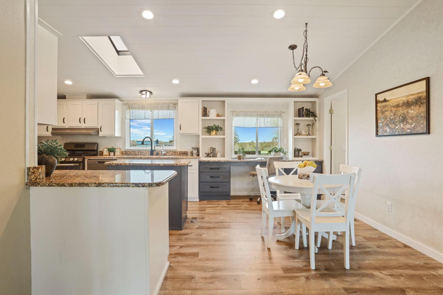 3320 Durham Ferry Road Tracy, CA 95304 - Photo 22 of 77 a kitchen with stainless steel appliances kitchen island granite countertop a dining table chairs and sink