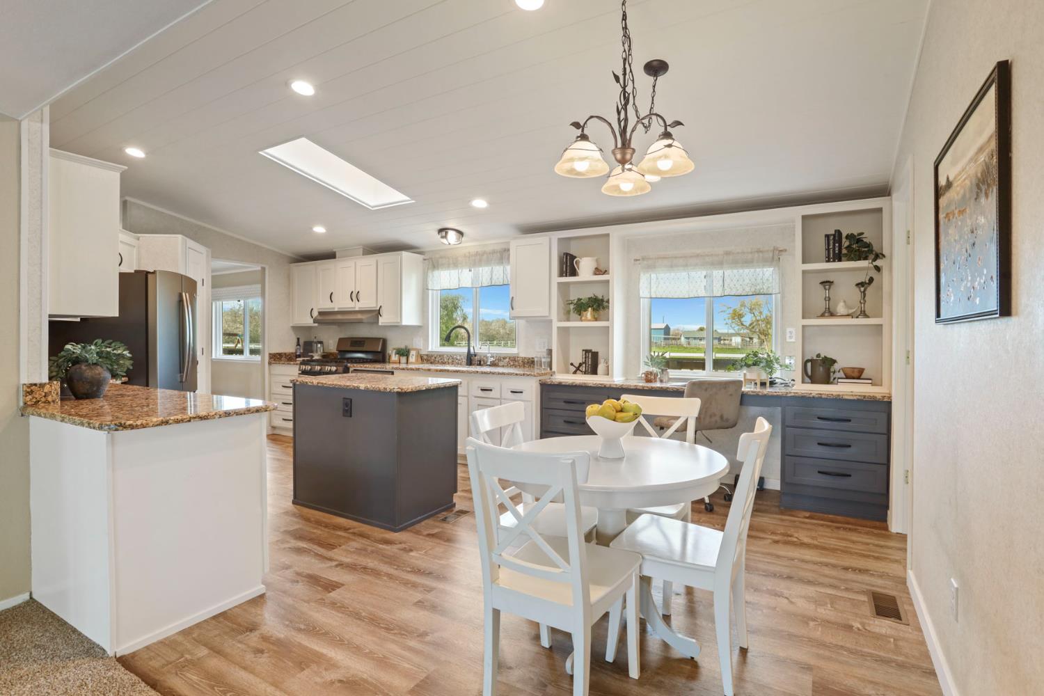 3320 Durham Ferry Road Tracy, CA 95304 - Photo 23 of 77 a kitchen with counter space dining table and stainless steel appliances