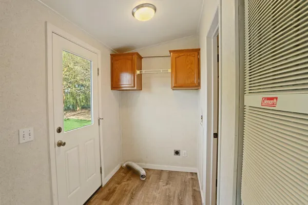 a bedroom with a bed a mirror and a lamp on dresser