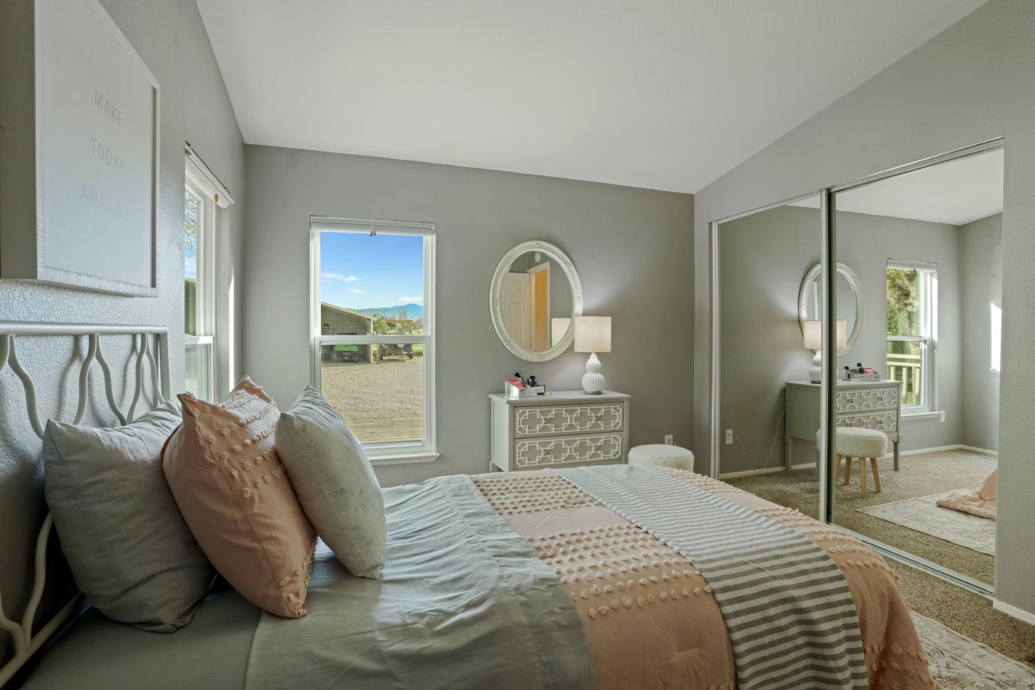 3320 Durham Ferry Road Tracy, CA 95304 - Photo 34 of 77 a bedroom with a bed a mirror and a lamp on dresser