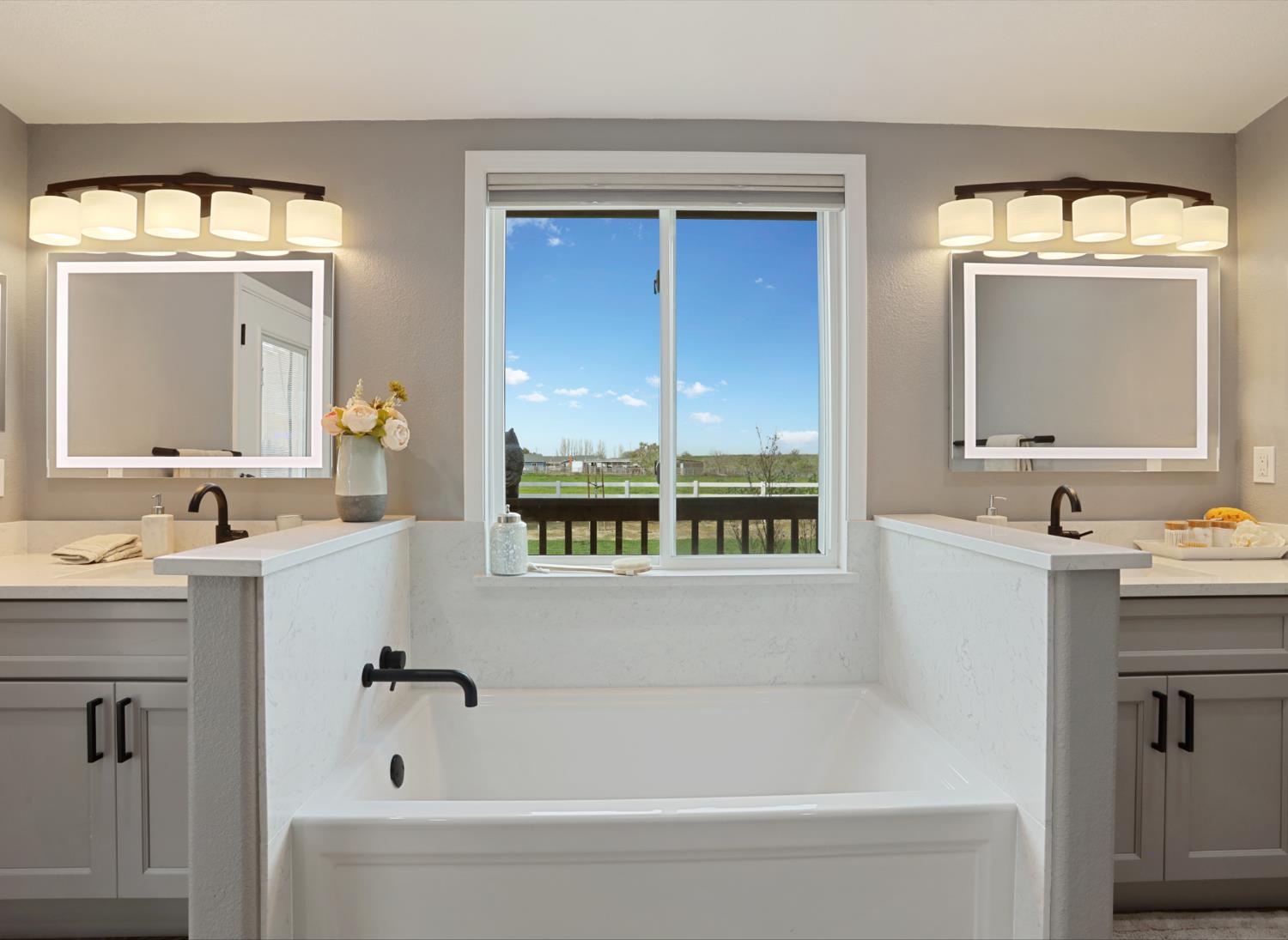 3320 Durham Ferry Road Tracy, CA 95304 - Photo 39 of 77 a bathroom with a bathtub sink and mirror