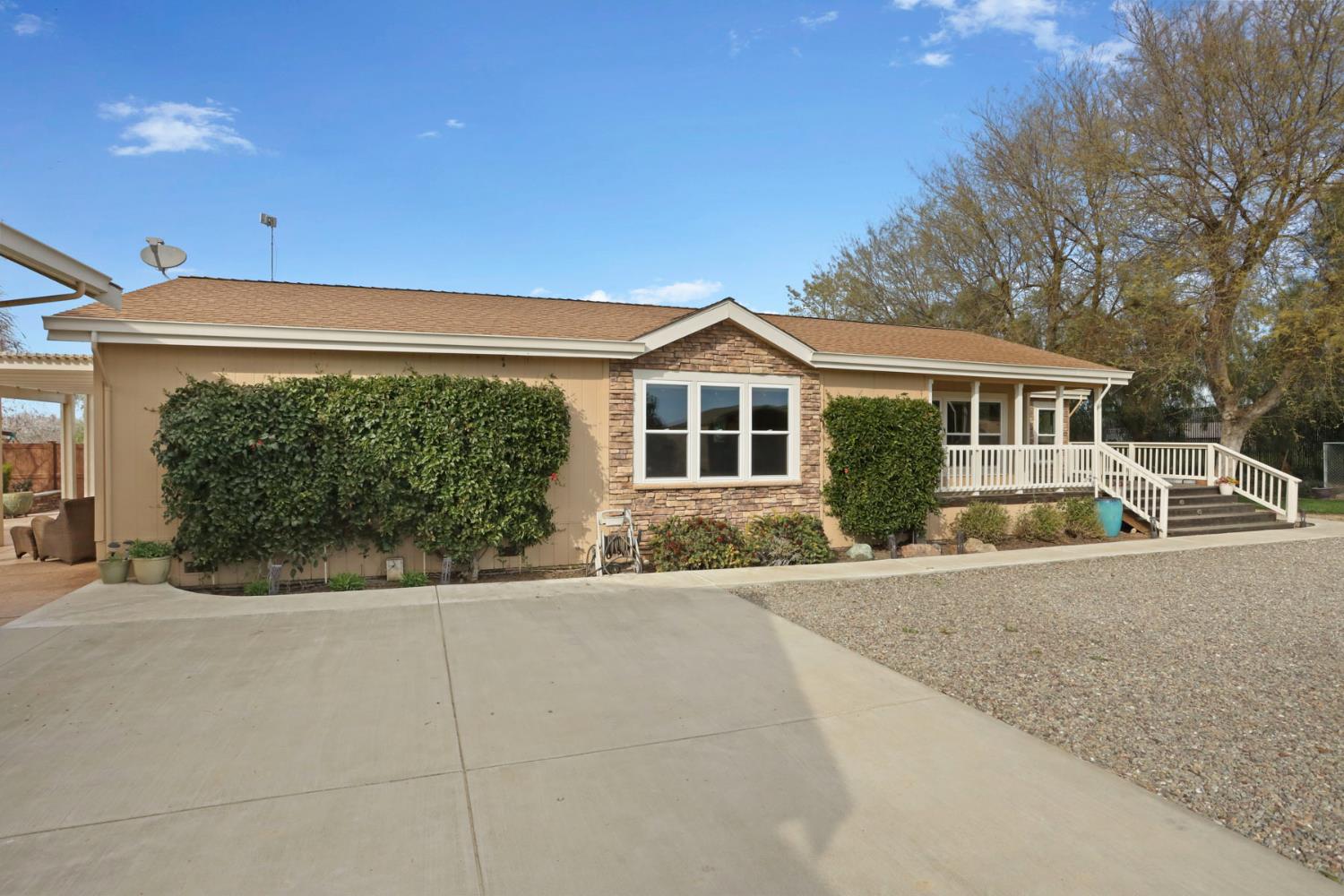 3320 Durham Ferry Road Tracy, CA 95304 - Photo 6 of 77 a front view of a house with a yard and potted plants