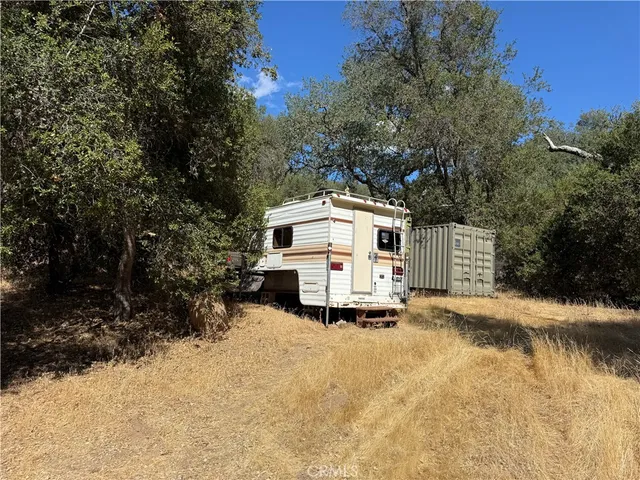a white house that has a tree in front of it