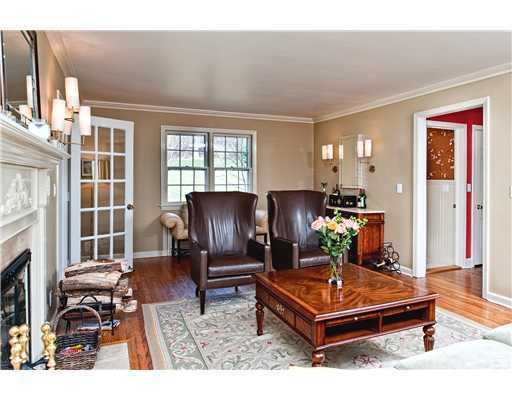 Undisclosed Address Darien, CT 06820 - Photo 4 of 9 a living room with furniture a dining table and a fireplace