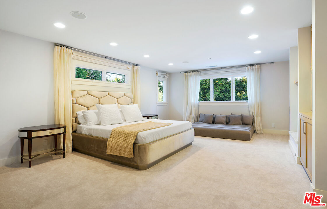 2547 Hutton Drive Beverly Hills, CA 90210 - Photo 17 of 27 a spacious bedroom with a large bed and a couch