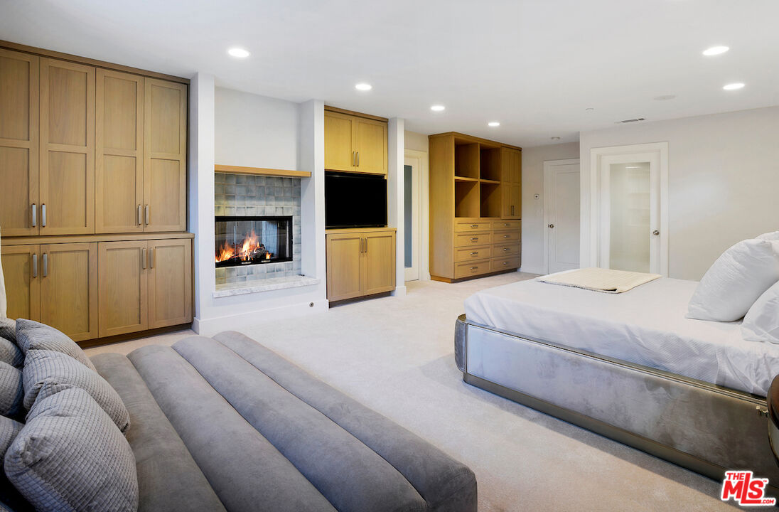 2547 Hutton Drive Beverly Hills, CA 90210 - Photo 18 of 27 a bedroom with a large bed and a television