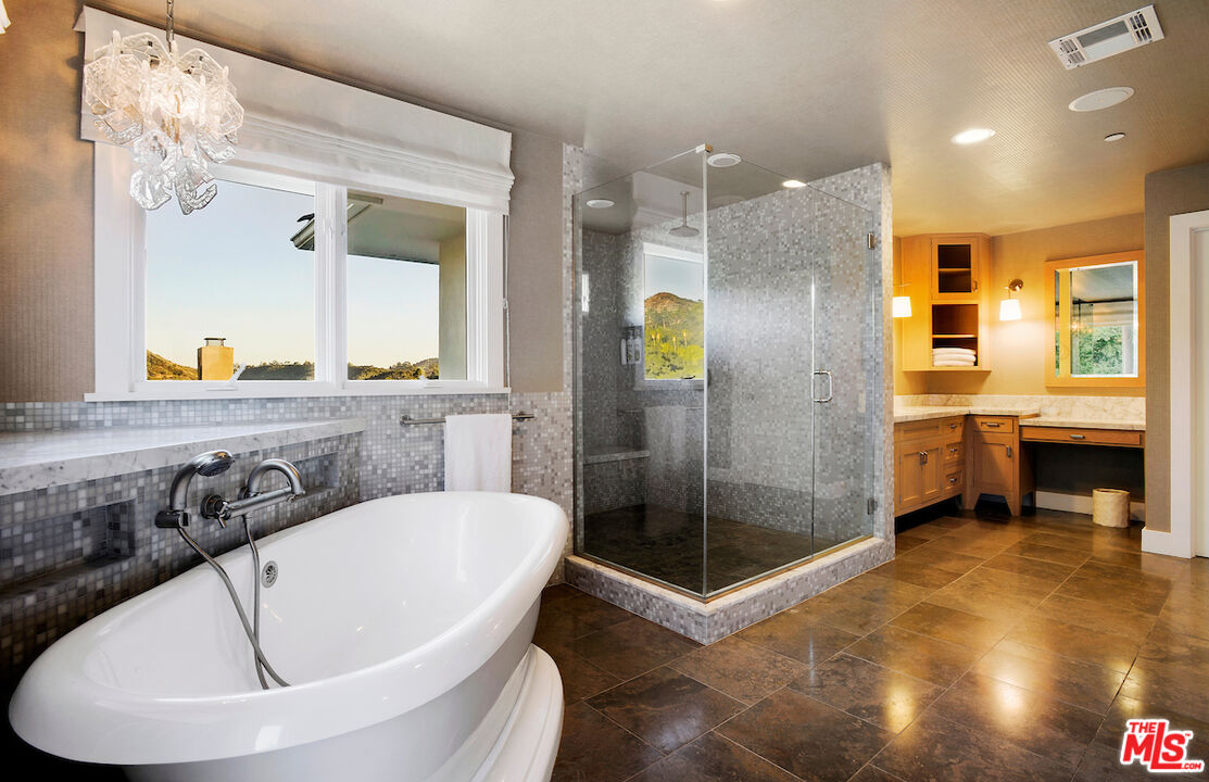 2547 Hutton Drive Beverly Hills, CA 90210 - Photo 21 of 27 a bathroom with a tub a sink a mirror and a shower
