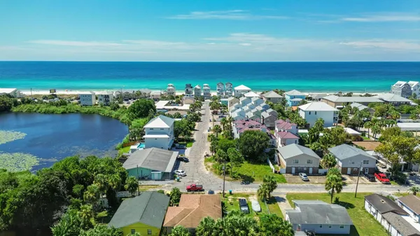 an aerial view of a houses with a lake view