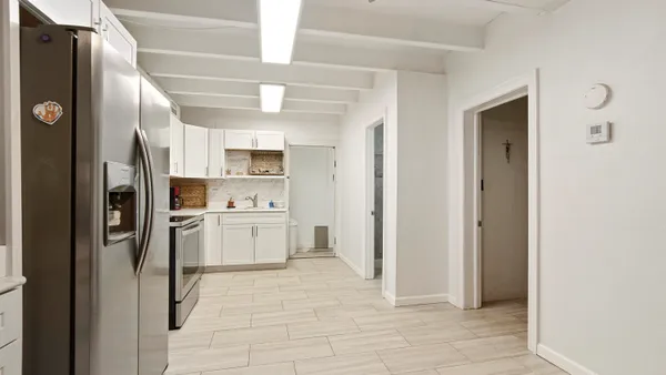 a kitchen with a refrigerator and cabinets