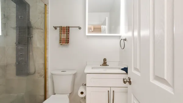 a bathroom with a sink toilet and shower