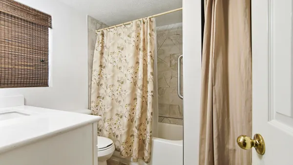 a bathroom with a sink and mirror with toilet