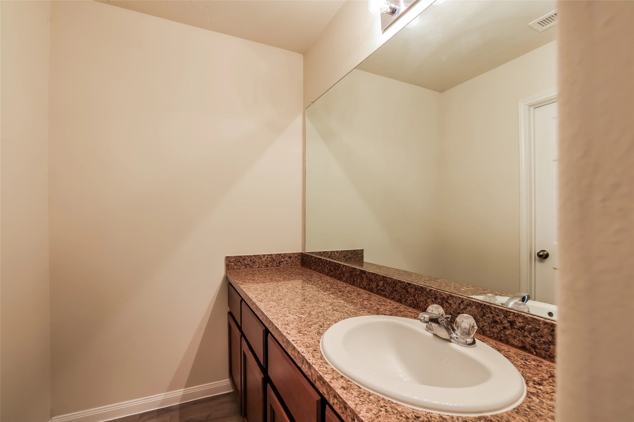 14438 Acuna Lane Houston, TX 77045 - Photo 11 of 15 a bathroom with a granite countertop sink and a mirror