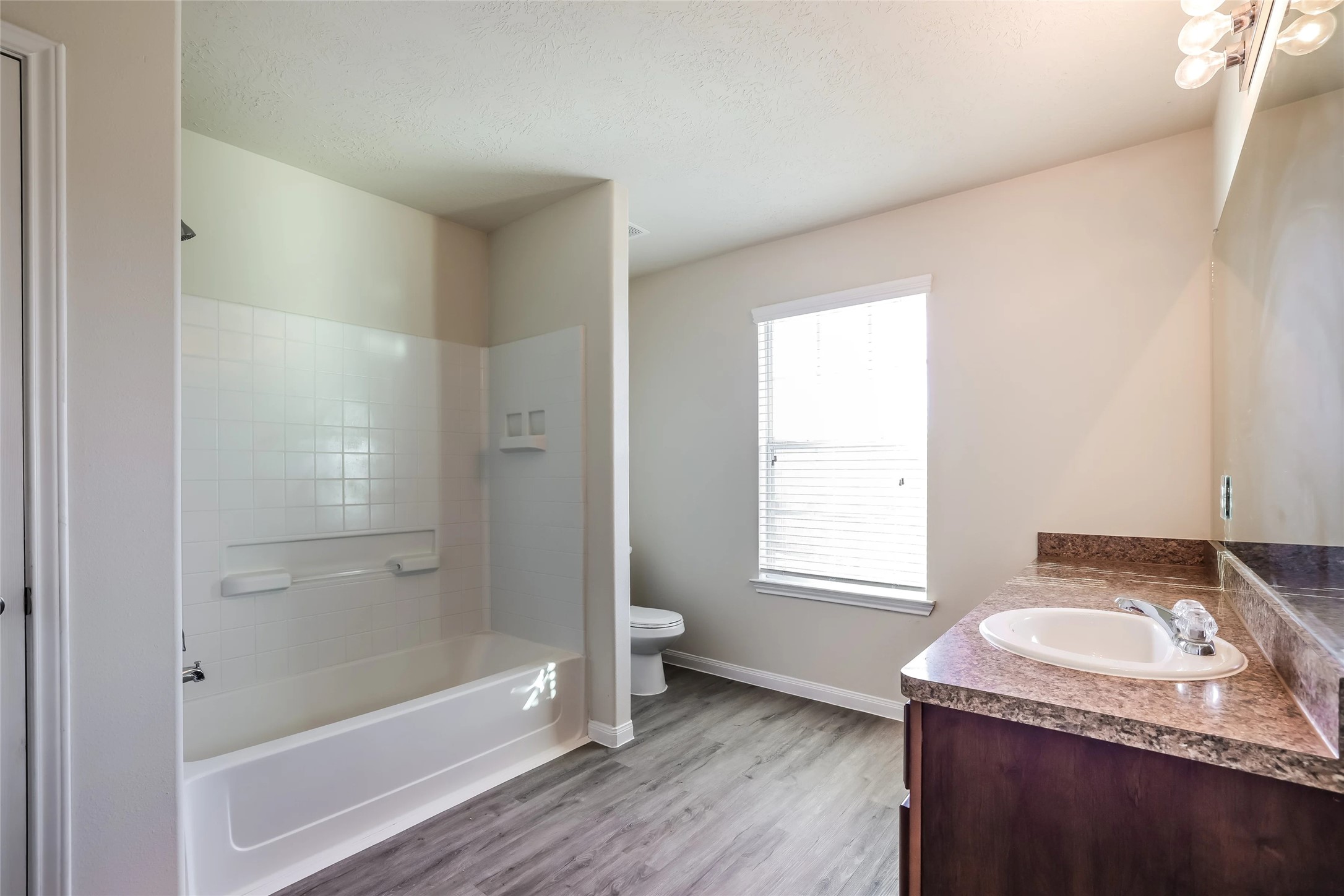 14438 Acuna Lane Houston, TX 77045 - Photo 13 of 15 a bathroom with a granite countertop sink a toilet and shower