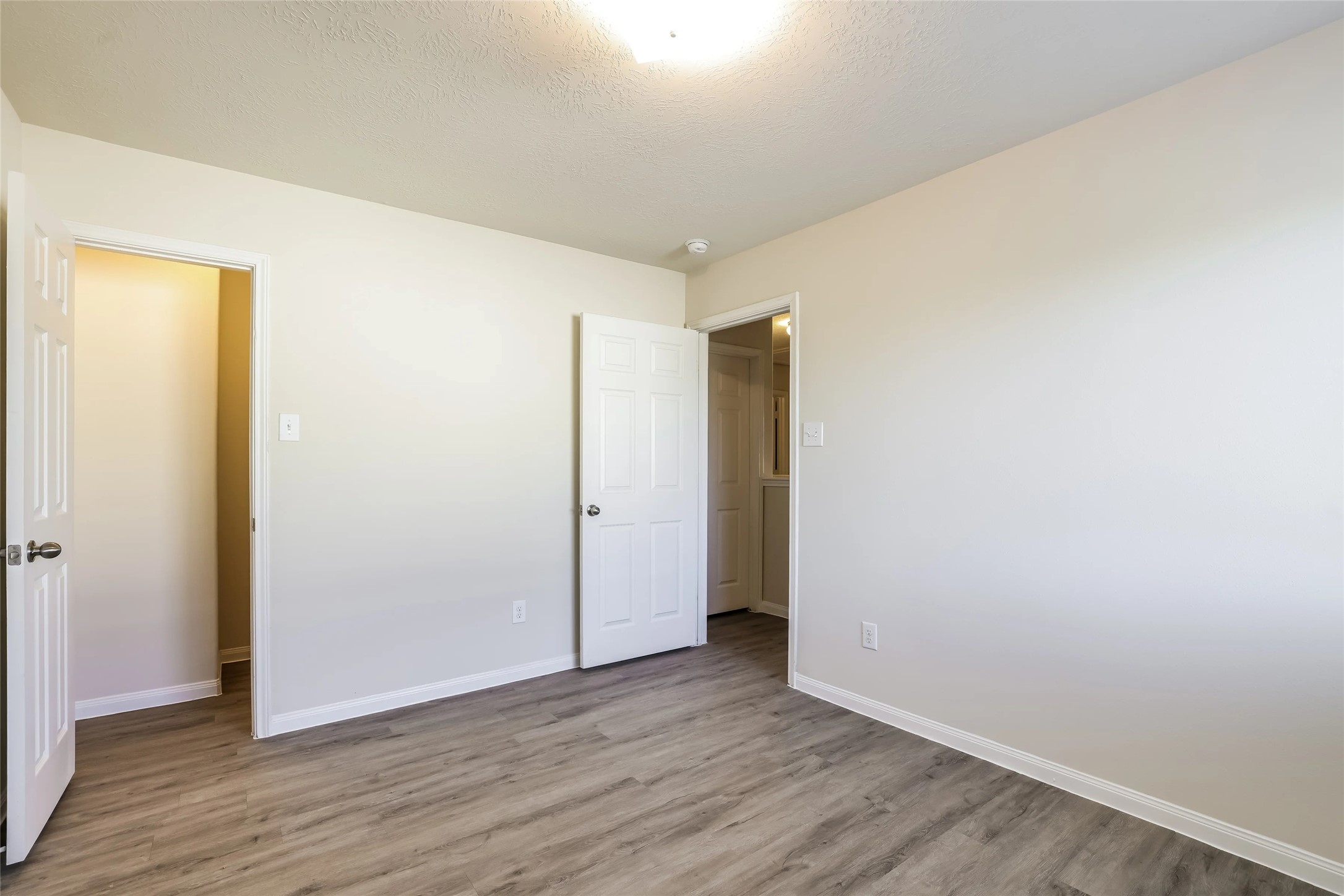 14438 Acuna Lane Houston, TX 77045 - Photo 9 of 15 a view of an empty room with wooden floor
