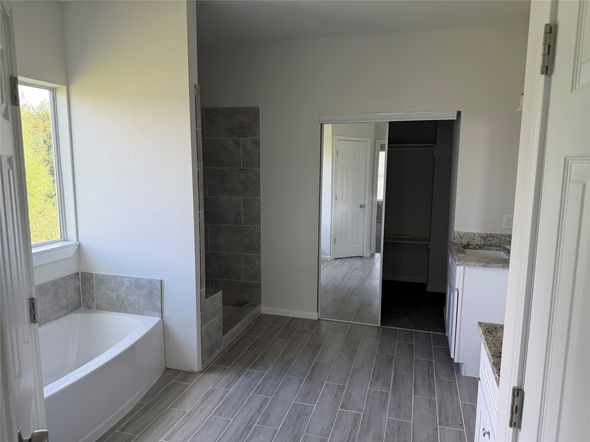 7952 Blue Street Houston, TX 77028 - Photo 6 of 14 a bathroom with a bathtub and a shower