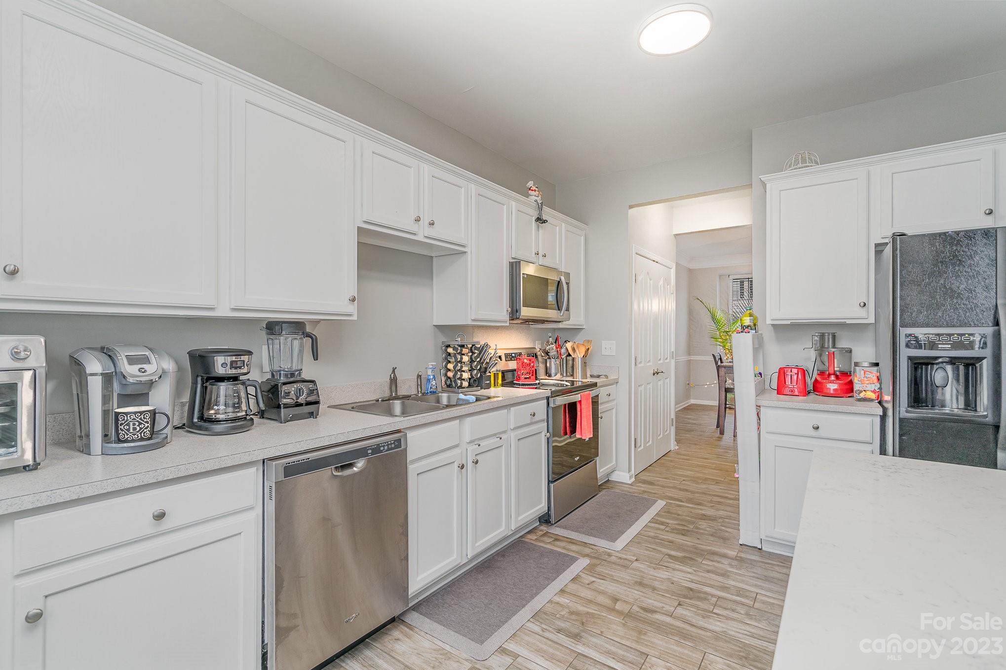7572 Bluff Point Lane Denver, NC 28037 - Photo 14 of 33 a kitchen with stainless steel appliances granite countertop a refrigerator sink and stove