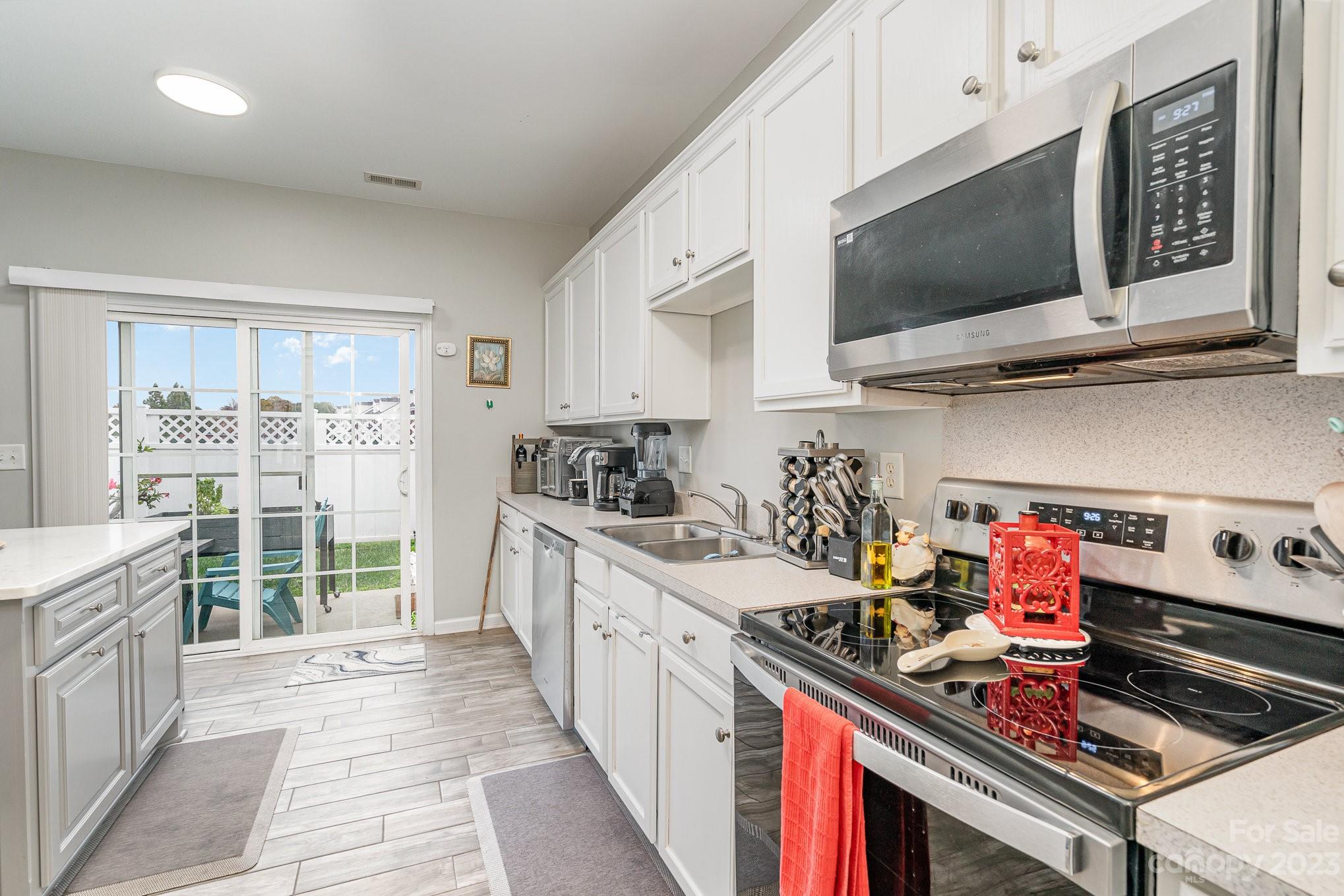 7572 Bluff Point Lane Denver, NC 28037 - Photo 15 of 33 a kitchen with a stove and a microwave