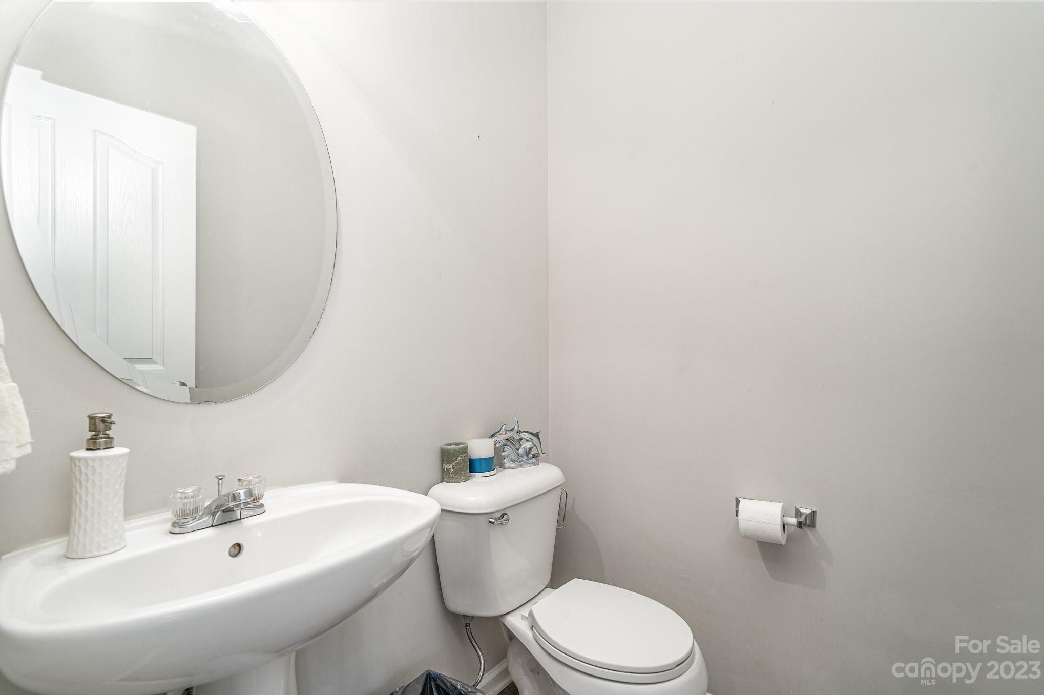 7572 Bluff Point Lane Denver, NC 28037 - Photo 17 of 33 a bathroom with a sink a mirror and a toilet