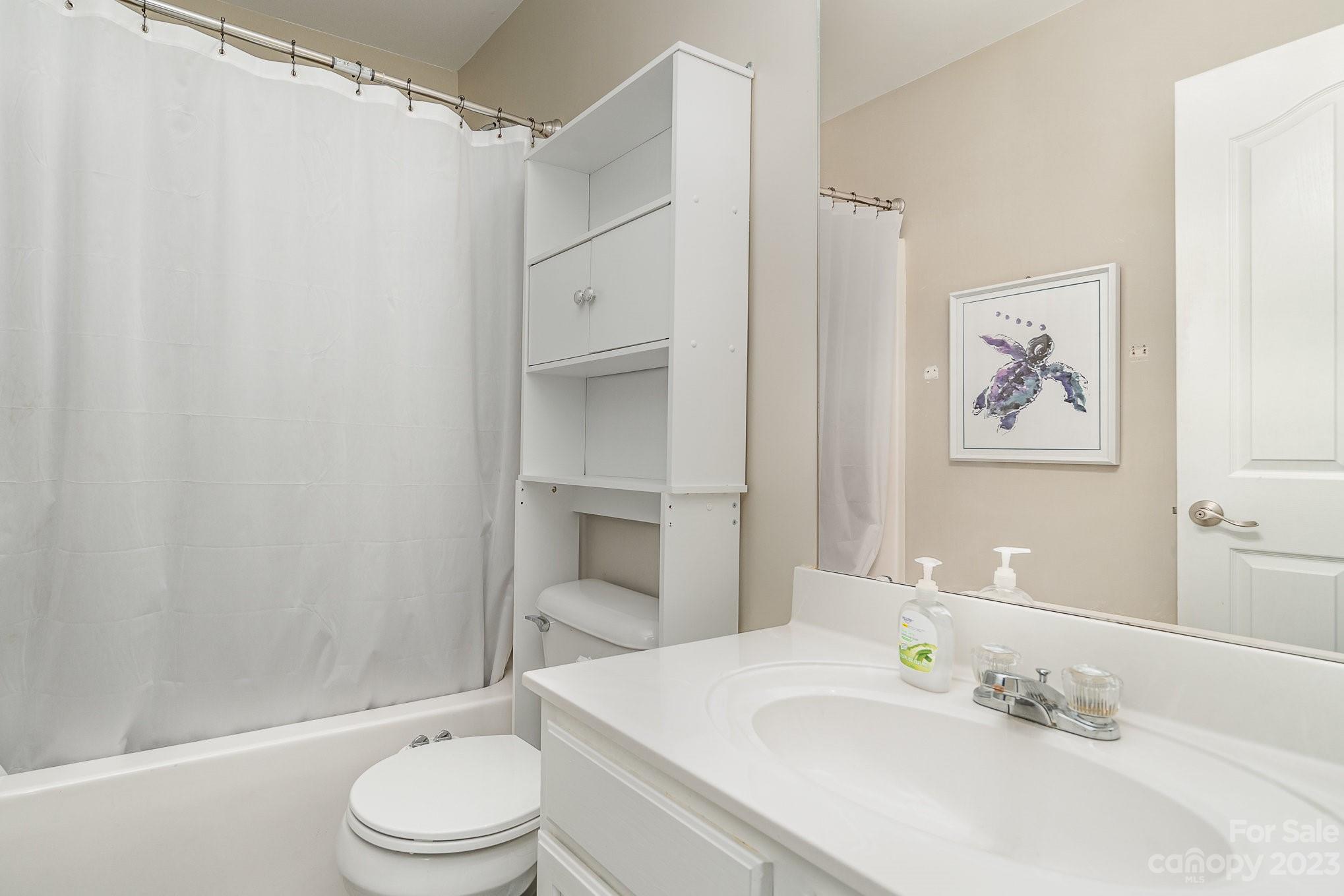 7572 Bluff Point Lane Denver, NC 28037 - Photo 28 of 33 a bathroom with a sink a toilet and shower