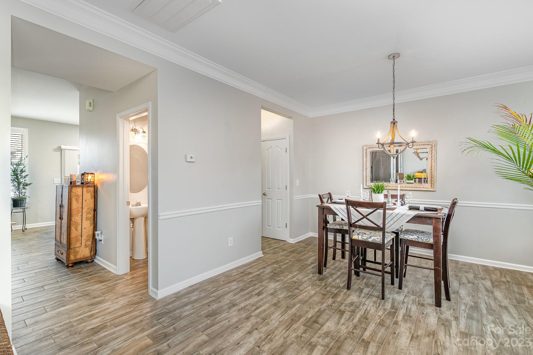 7572 Bluff Point Lane Denver, NC 28037 - Photo 5 of 33 a dining room with furniture and wooden floor