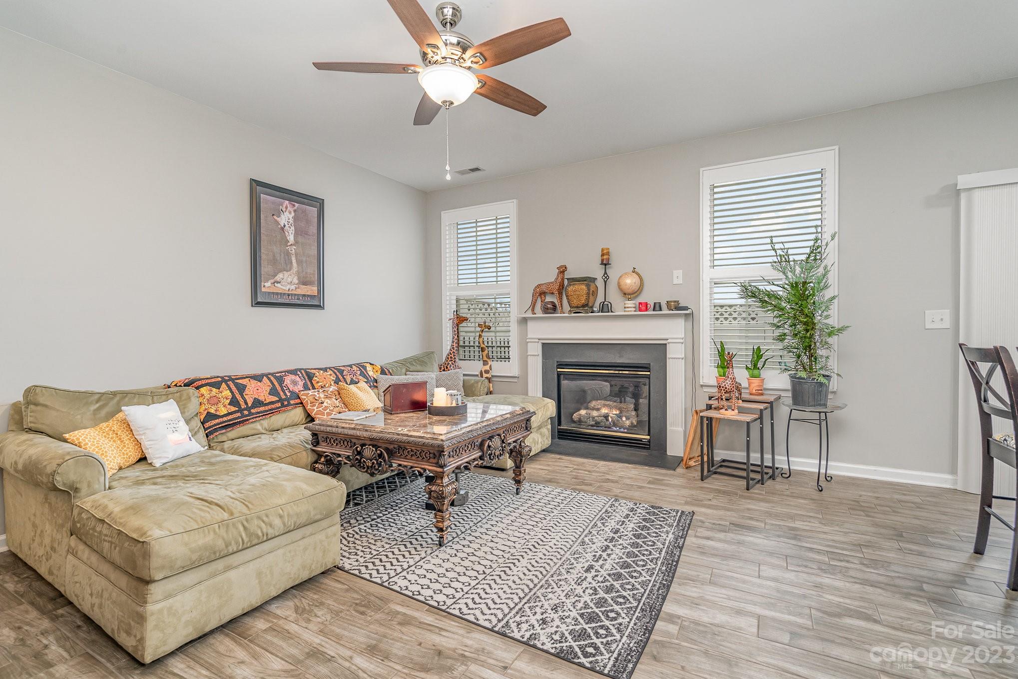 7572 Bluff Point Lane Denver, NC 28037 - Photo 9 of 33 a living room with furniture and a fireplace