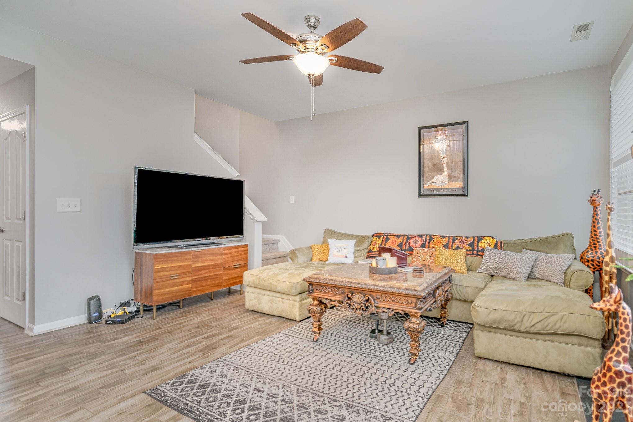 7572 Bluff Point Lane Denver, NC 28037 - Photo 10 of 33 a living room with furniture and a flat screen tv