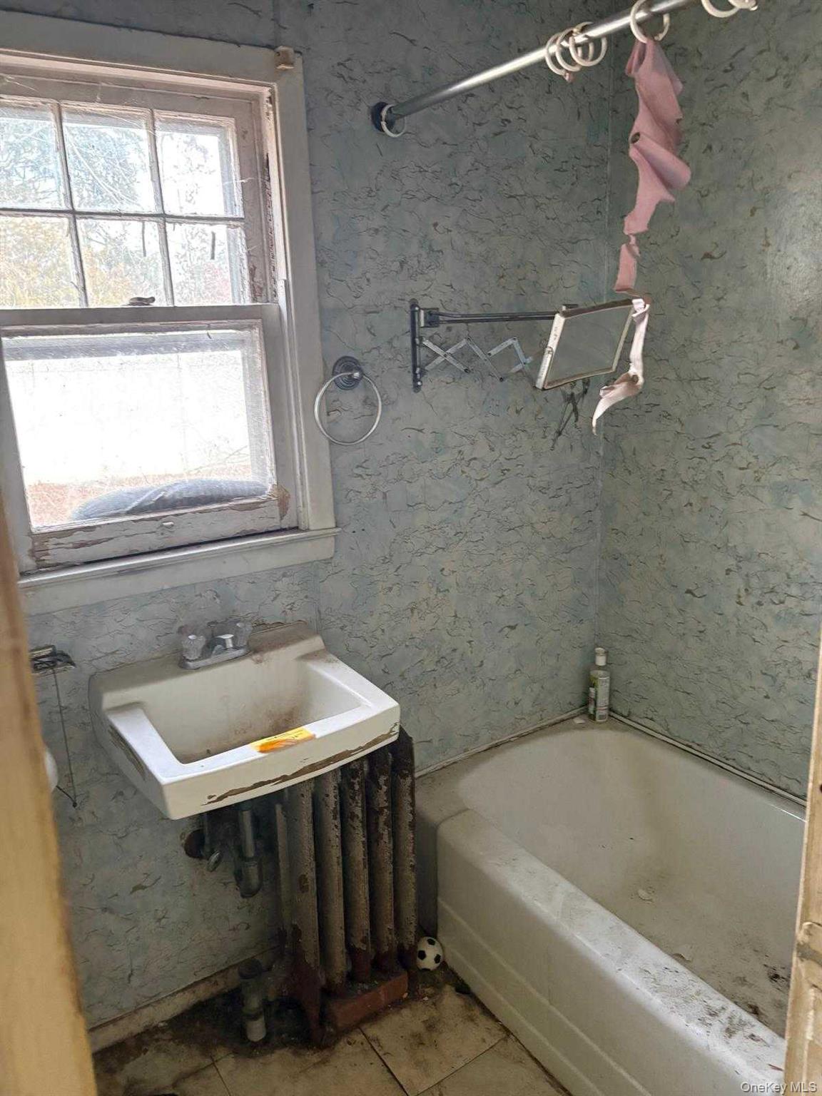19 Lacrosse Road Mastic Beach, NY 11951 - Photo 11 of 15 a bathroom with a sink and a bathtub