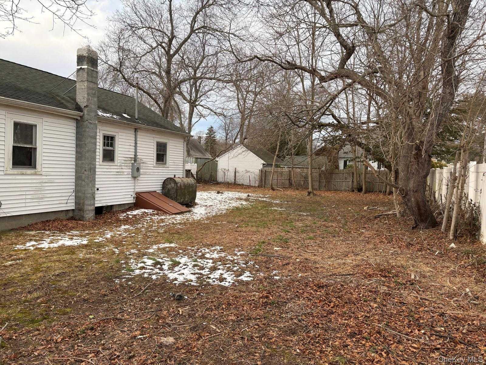 19 Lacrosse Road Mastic Beach, NY 11951 - Photo 4 of 15 a view of a house with backyard