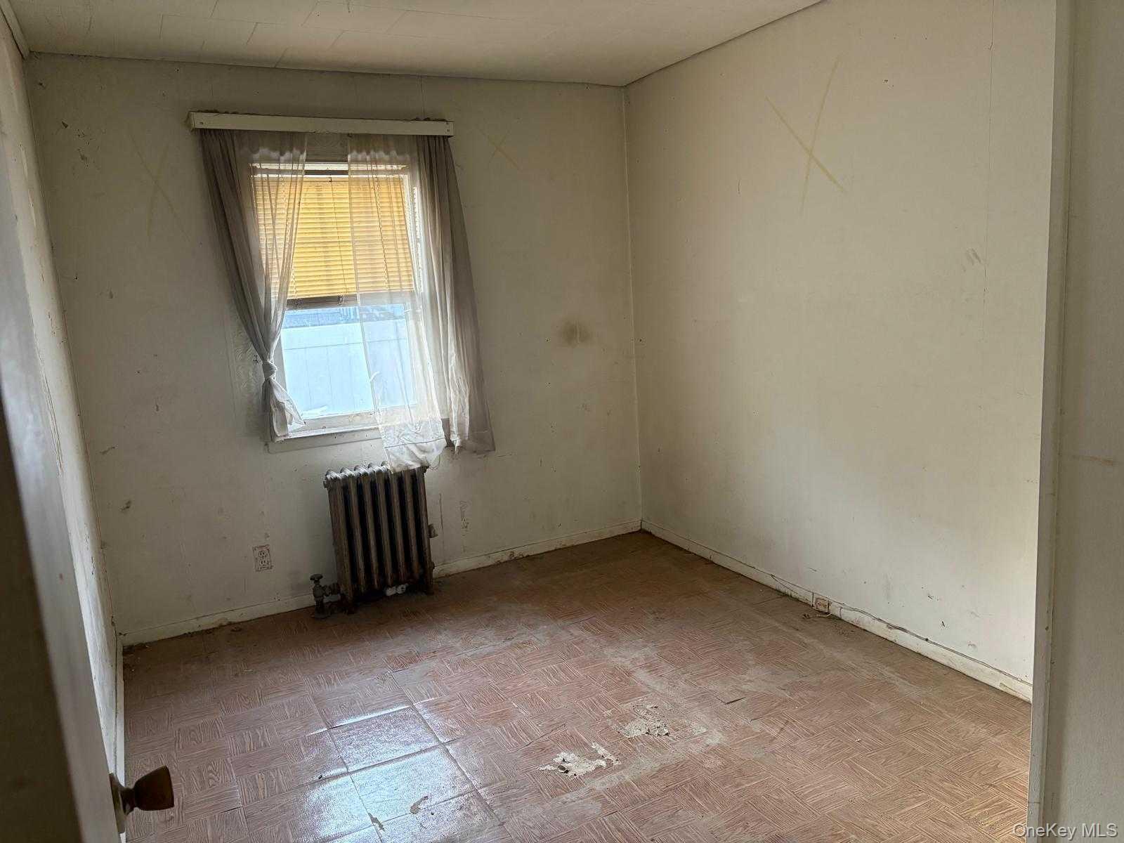 19 Lacrosse Road Mastic Beach, NY 11951 - Photo 8 of 15 an empty room with a window