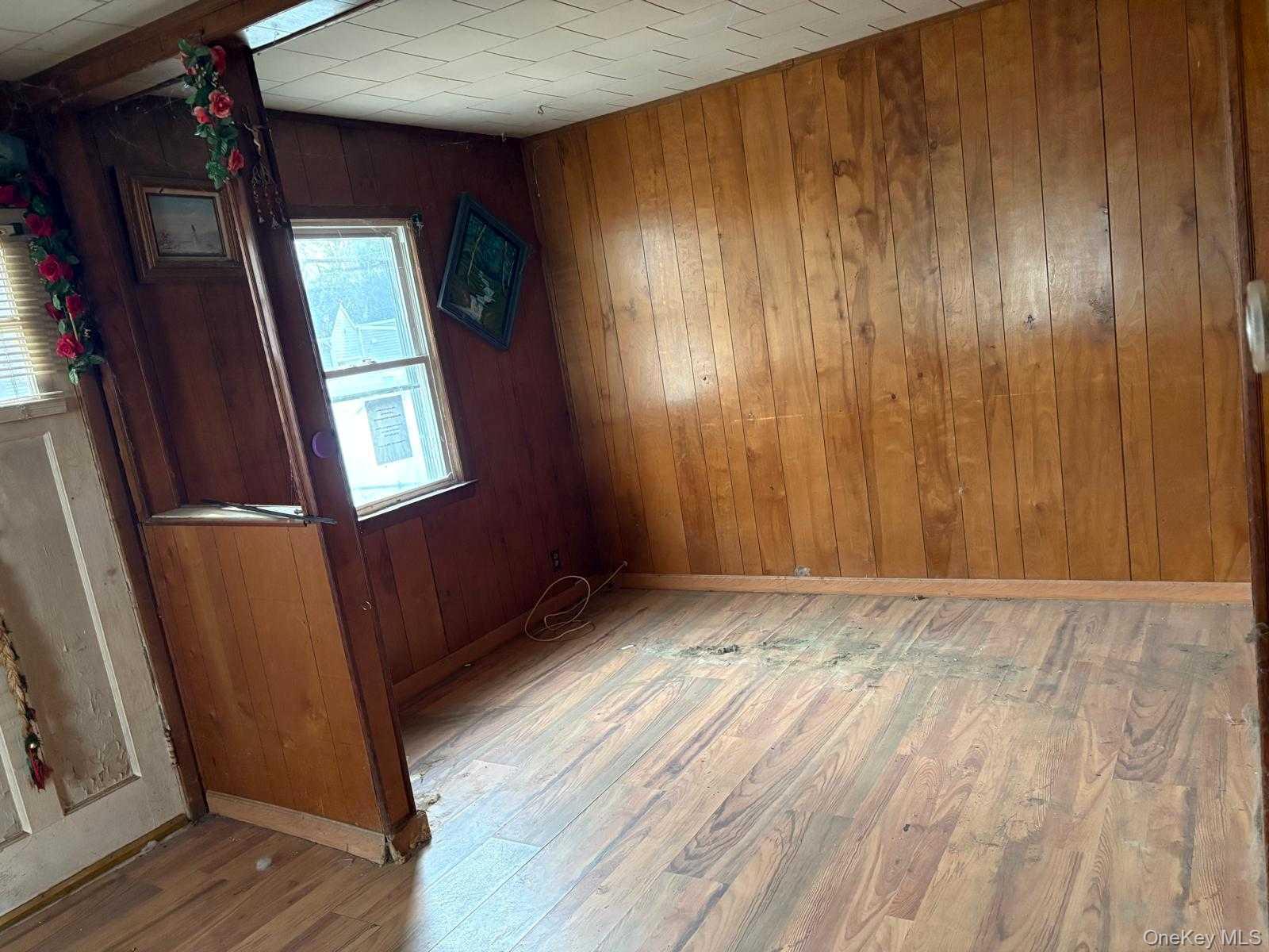 19 Lacrosse Road Mastic Beach, NY 11951 - Photo 9 of 15 a view of an empty room with wooden floor and a window