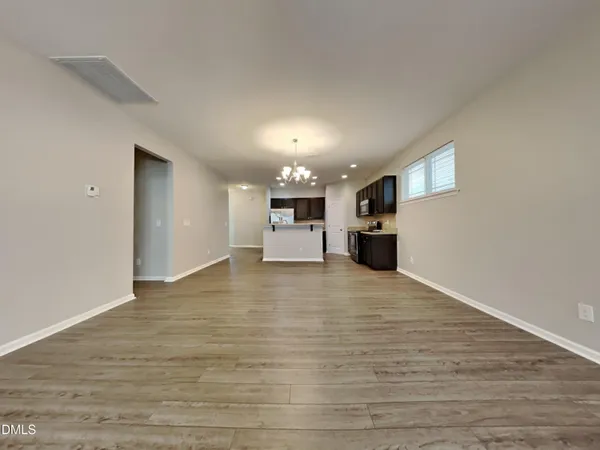 a view of a kitchen with a sink and a refrigerator
