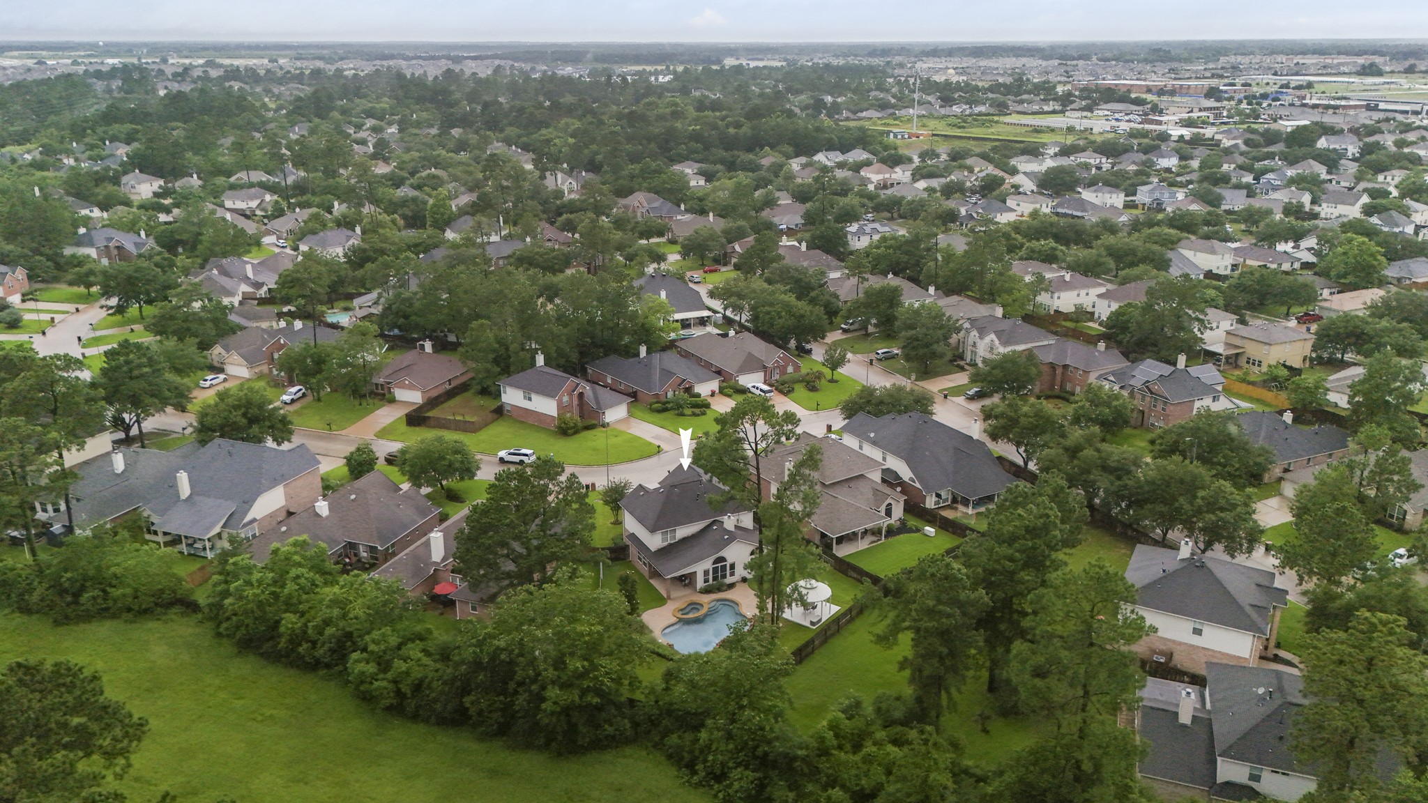 6311 Sparrows Glen Lane Spring, TX 77379 - Photo 2 of 50 This aerial view frames the home within Windrose and gives a first look at the backyard setting—pool + spa, gazebo, and green space beyond the fence with no rear neighbors.