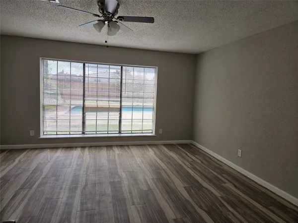 a view of a room with stairs and a wooden floor