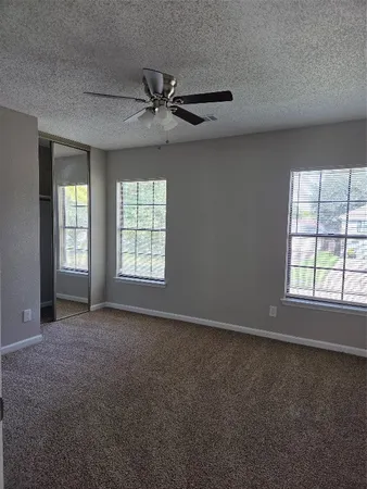 an empty room with a empty space and windows