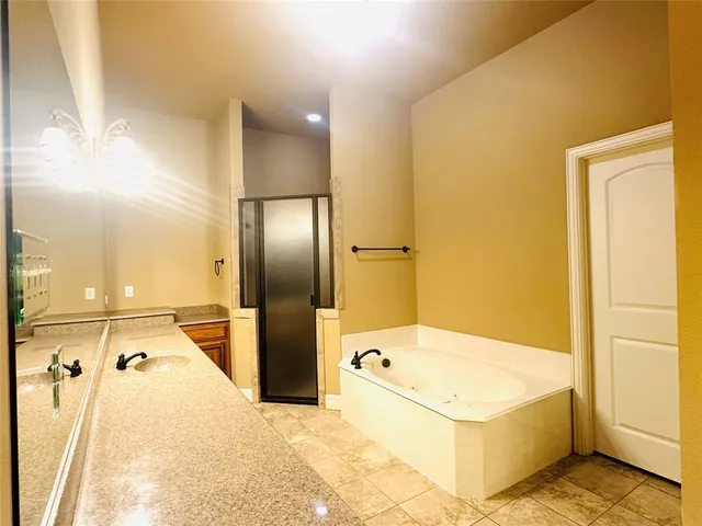 a bathroom with a tub and a shower