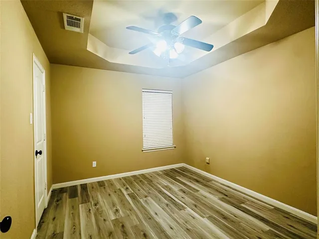 a view of a room with a dishwasher and a white cabinet