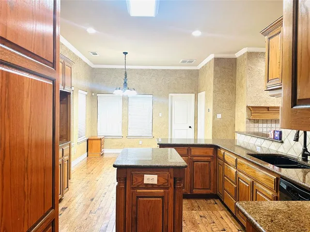 a kitchen with stainless steel appliances a sink stove and cabinets