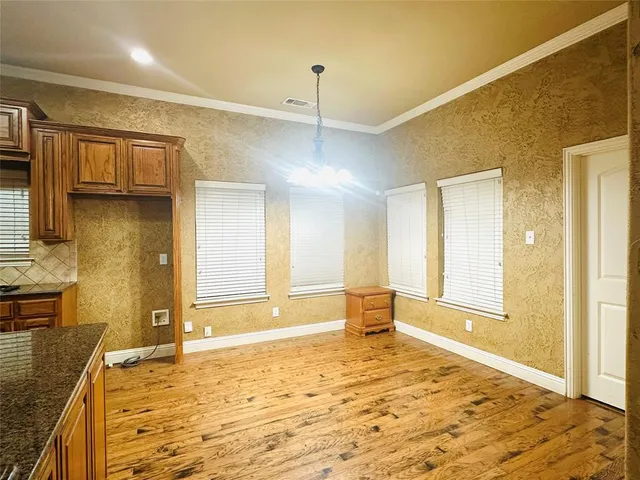 a view of a kitchen with wooden floor and a sink