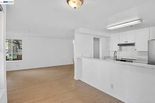 a kitchen with refrigerator and stove