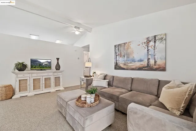 a living room with furniture kitchen and a table