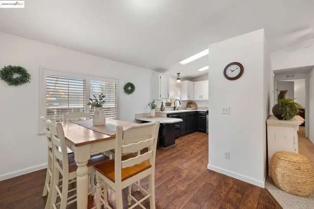 a view of a dining room with furniture and a large window