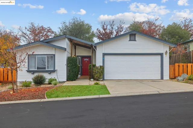 a view of a house with a yard and garage