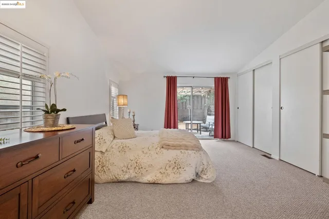 a spacious bedroom with a large bed and a window