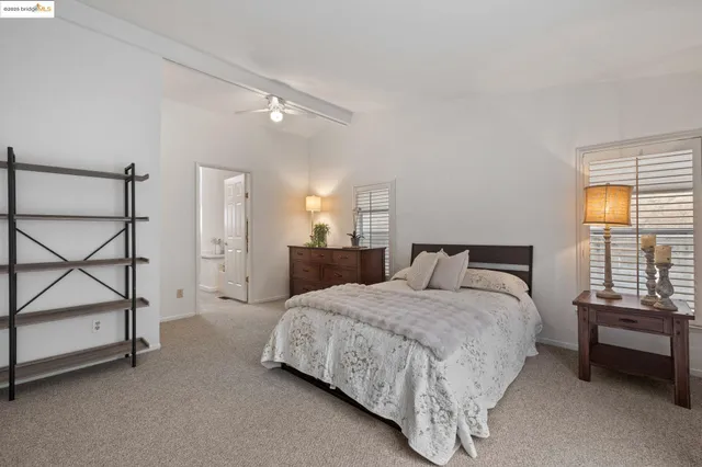 a spacious bedroom with a bed and a window